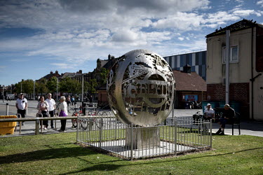 People look at a sculpture celebrating the town of Blyth's industrial past, in the once thriving centre of the town which has become increasingly deprived since the closure of its coal mining industry...