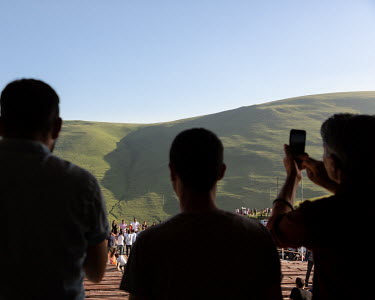 Men photograph the silhouette of Turkey's founder, Mustafa Kemal Ataturk, on the side of a hill in Ataturk village, near Damal on Turkey's border with Georgia. The silhouette shadow appears for a mont...