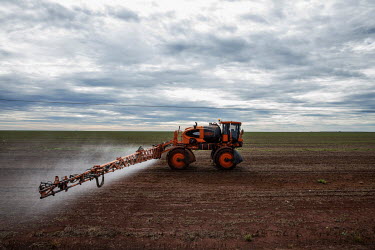 An agricultural vehicle sprays pesticide on a farm in Chapada dos Parecis near the headwaters of the Jauru River, a key plateau in the wetlands of the Pantanal.
