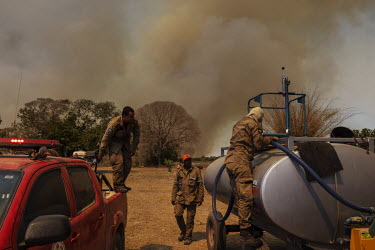 Firefighters prepare equipment to fight a fire on a farm near the Transpantaneira road, in Mato Grosso.