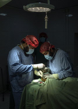 Medecins Sans Frontieres (MSF) surgeons operate on the foot of a man injured by a mine and previously poorly operated on in a public hospital