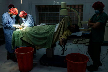 Medecins Sans Frontieres (MSF) surgeons operate on the foot of a man injured by a mine and previously poorly operated on in a public hospital