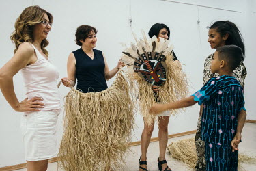 In preparation for the 10th annual Dana Bayram (Calf Festival) held in Izmir, Adel (far right) is shown generic African costumes designed by a Turkish costume designer.