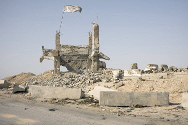 A ruined building topped with a Taliban flag along the road between Kandahar and Lashkar Gah.