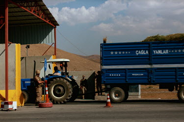 Members of the Turkish Jandarma forces on duty at a checkpoint near the Iranian border search a tractor and trailor as they try and stop human trafficking from Iran. It is one of several measures take...