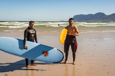 Yusuf and Atyab from Joburg, data analysts. 25 years old and beginner surfers, Cape Town beach.
