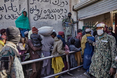 Taliban border guards control the crowds of Afghans waiting to enter Pakistan at the border crossing in Spin Boldak. Between three and four thousand Afghans cross this border every day in the hope of...