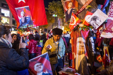A man sells Turkish flags, scarves and, memorabilia with the face of Mustafa Kemal Ataturk on them, at the annual Victory Day celebration on Bagdat Caddesi.