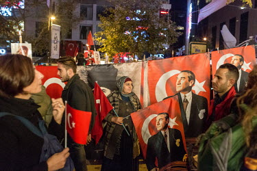 A woman sells Turkish flags, scarves and, memorabilia with the face of Mustafa Kemal Ataturk on them, at the annual Victory Day celebration on Bagdat Caddesi.