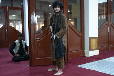 A Taliban provides security during main Friday prayers at the Abdul Rahman Khan Mosque