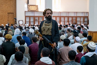 A Taliban provides security during main Friday prayers at the Abdul Rahman Khan Mosque