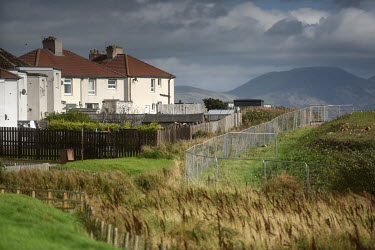 The mountains of the Lake District National Park rise in the distance behind rows of houses in the Kells and Sandwith area of Whitehaven where plans to open a new coal on the site of a former chemical...