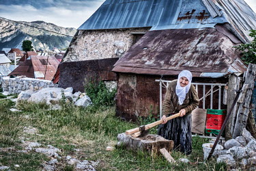 Rahima Comor, 79, splits wood from her stock of wood to heat her house in Lukomir. Lukomir is a highland village in Bosnia Herzegovina, the highest and most isolated permanent settlement in the countr...