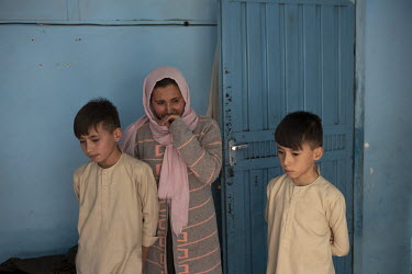 Sumaya with her children Shobayr and Zahir. The two children who had to stop school because their parents could no longer afford the fees. Their mother Sumaya was able to get some cash from a World Fo...