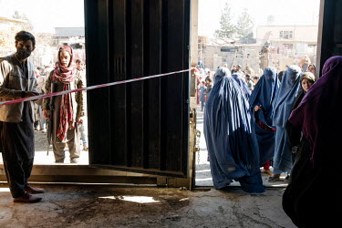 A Taliban on security duty during a distribution of cash by the World Food Program to the poorest people at a former gymnasium.