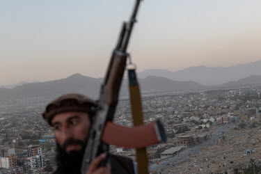 A Taliban poses for pictures atop Wazir Akbar Khan hill.