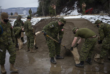 Canadian soldiers fill sandbags to use in flood barriers as unprecedented rainfall, throughout the province, triggered landslides and devastating flooding on 14 November 2021, leaving countless people...
