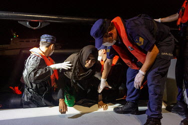 Migrant women and children, from a group of 20 Afghans, are rescued by the Turkish coastguard from two life rafts drifting at night in the northern Aegean Sea. All those on board claim to have been fo...