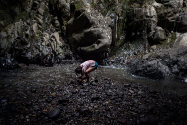 Lizet Tuquerres, a 15 year old Karanki woman, washes in 'Las Tres Cascadas'.