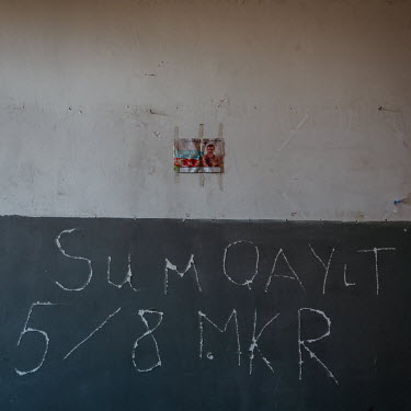 A picture of a 'martyred' Azeri soldier stuck to the wall of a school room in a rural village that was used by Azeri military during the 2020 Nagorno-Karabakh war with Armenia.