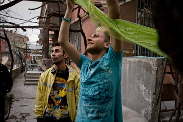 Ali Reza (L, 28) and Pedram (19), from Tehran and Shiraz, Iran.They live together in a house well known amongst the Iranian LGBT community, Ali Reza and Pedram place a plastic sheet over their garden,...