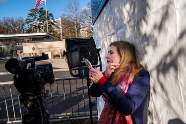 TV journalist preparing make up before going live as part of the nternational press reporting from outside the US Mission in Geneva, as Russian and US diplomats hold talks over tensions in Ukraine.