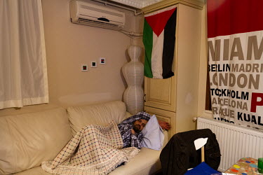 Mahmoud Hassino sleeping on a friend's sofa in Istanbul. After leaving Damascus, Mahmoud lived in Turkey for around three years, from where he worked as a journalist covering the conflict in his nativ...