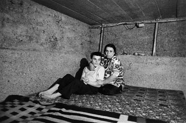 An ethnic Albanian woman and her disabled son who fled their village and settled in the shell of an unfinished house in the village of Gullbovc.