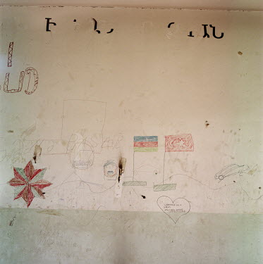 A former school near Fusili with Armenian writing at the top, which has been partially removed, and the walls covered with Azerbaijani graffiti, including a Turkish flag, one of Azerbaijan's key milit...