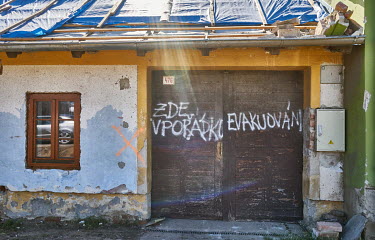The inscription on the door of a house, which was damaged by a tornado, reads 'Okay here, evacuated'. Around 68 houses had to be demolished after a deadly tornado swept through several villages in Sou...