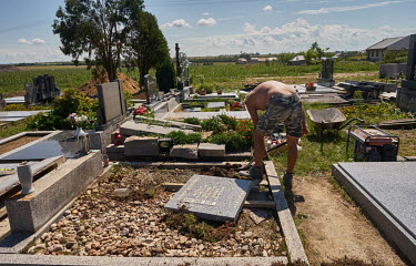 A stone mason repairs a damaged tombstone in a cemetery that was hit by a deadly tornado that swept through several villages in South Moravia on 24 June 2021, killing six people and leaving about 200...
