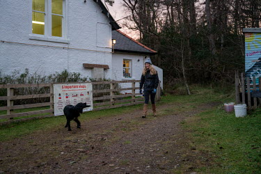 Teacher Susie Murphy with her pet dog as she makes her way to the island's school in the early morning