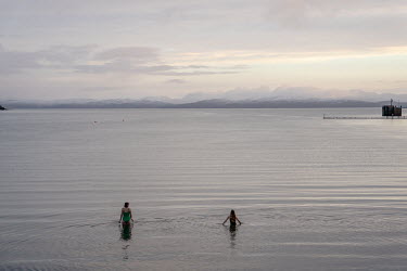 Islanders go for an early morning swim the bay at Kinloch.