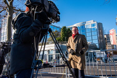 A BBC journalist shoots a piece to camera outside the President Wilson Hotel where talks were due to take place between American and Russian foreign ministers in an attempt to reduce the tensions over...