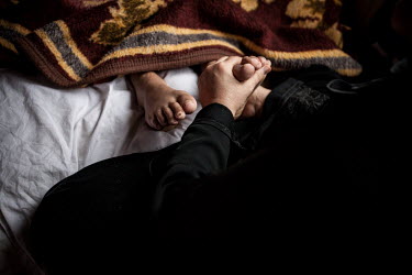 12 year old Maysa Ziadeh's paralysed feet are massaged by her mother's hands in the hope that it might bring some sensation back. After being injured, Maysa had to be hidden in a cave for a month befo...