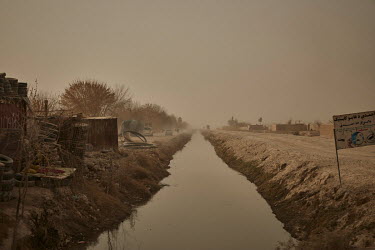 An irrigation canal in the arid landscape of Helmand. Water was recently released from a nearby reservoir to help farmers as the area continues to suffer from drought.