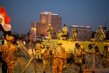 Egyptian military troops guard the road, protecting anti-Morsi demonstrators on Kasr al-Nile Bridge, leading to Tahrir Square.