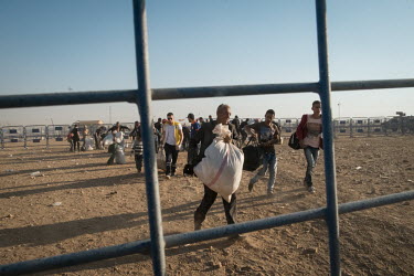 Syrian refugees cross into Turkey fleeing clashes between Kurdish and Islamist forces in the town of Kobani in Syria