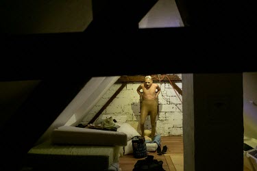 Shayma adds foam hips to their drag body in the attic of a gay club.  Shayma is a Tunisian drag performer and long time LGBTI activist who relocated to Germany after their situation and safety in Tuni...