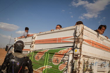 A truck carrying Syrian Kurdish refugees from Kobane/Ayn al-Arab arrives outside a refugee camp set up for the estimated 130,000 people flooding into Turkey to escape an offensive by Islamic State mil...
