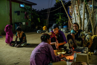Urmila Parteti (second from right) with her mother Shantabai Parteti cooks dinner at her home in Bilawar Kala village. She and her family say they are under social pressure by the villagers of Bilawar...