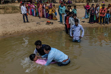Local pastors baptise villagers on the banks of a river in Imamgunj district.