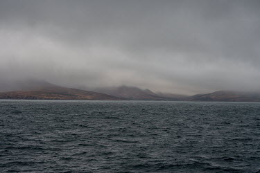 Low cloud obscures the land as a ferry approaches the Isle of Rum.