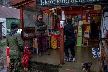 Islanders gather at the island's only shop in Kinloch.
