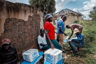 People with their aid items distributed by UNHCR to people returning from refugee camps in Uganda. Food rations have been cut by two thirds in the refugee camps in Uganda. People have been sheltering...