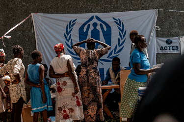 Women queue at an UNHCR distribution of non-food items to 300 families who have recently arrived in Pajeri from Uganda. Food rations have been cut by two thirds in the refugee camps in Uganda. People...