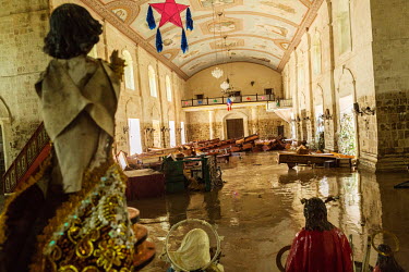 Flood water and damaged furniyure inside Loboc church in the aftermath of typhoon Rai. The level which the rising waters reached can be seen on the walls around the church.