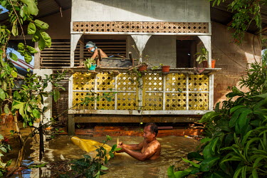 Members of the Caroro family tend to their house in the aftermath of typhoon Rai.