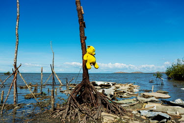 A teddy bear hangs from a tree with debris from houses lying around it in Barangay Fatima in the aftermath of typhoon Rai.  The impact in this area was immense. Almost all of the houses in this distri...
