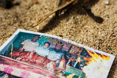 A family picture of happier times lies in the sand outside of a destroyed house on the island of Gaus.  The impact of typhoon Rai on many of the outer lying fishing islands north of Ubay was immense....